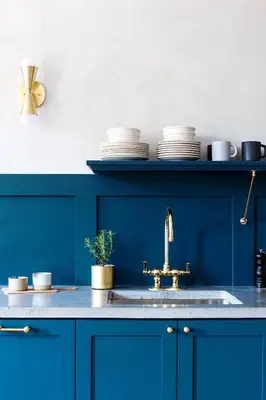 a blue kitchen with a sink and plates on a shelf at Lokal Hotel Old City in Philadelphia