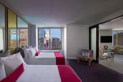 a hotel room with two beds and a large window at W New York - Times Square in New York