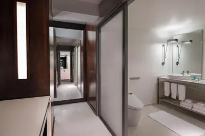 a bathroom with a toilet and a sink and a mirror at W New York - Times Square in New York