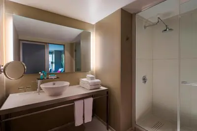 a bathroom with a sink and a shower at W New York - Times Square in New York