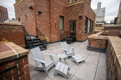 a patio with chairs and a table on a brick building at Lexington Plaza Hotel in New York