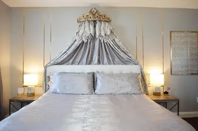 a bedroom with a large bed with a canopy at Mountain View Suites in Jim Thorpe