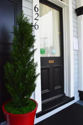 a christmas tree in a red pot in front of a door at Mountain View Suites in Jim Thorpe