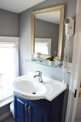 a bathroom with a sink and a mirror at Mountain View Suites in Jim Thorpe