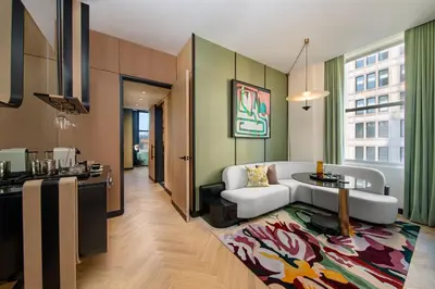 a living room with a couch and a table at W New York - Union Square in New York