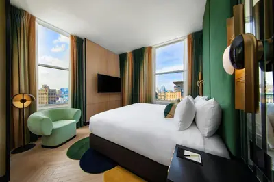 a hotel room with a bed and a large window at W New York - Union Square in New York