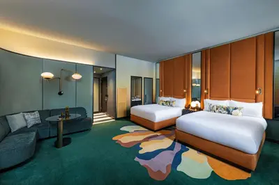 a hotel room with two beds and a couch at W New York - Union Square in New York