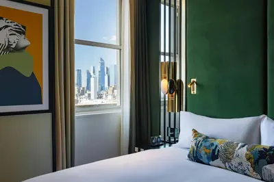 a bedroom with a bed and a window with a city at W New York - Union Square in New York