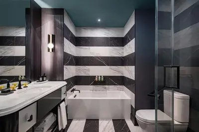 a bathroom with a tub and a toilet and a sink at W New York - Union Square in New York