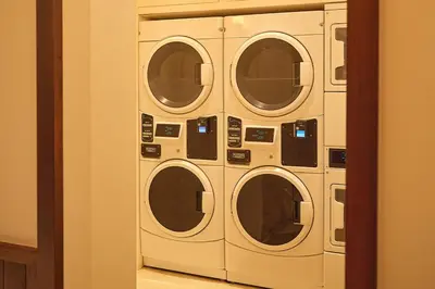 a group of four washing machines in a room at West Village Eurohostel in New York