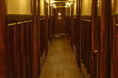 a hallway with wood paneled walls and a long hall with a door at West Village Eurohostel in New York