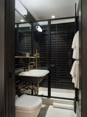 a bathroom with a sink and a toilet at The Moore, New York City, a Member of Design Hotels in New York
