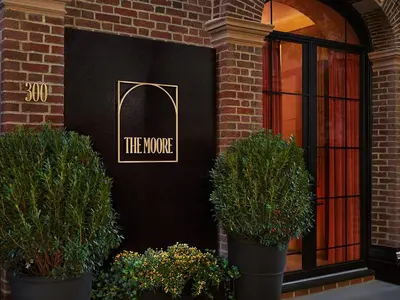 a store front with three potted plants in front of it at The Moore, New York City, a Member of Design Hotels in New York
