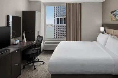 a hotel room with a bed and a desk with a computer at Hilton Garden Inn NYC Financial Center/Manhattan Downtown in New York