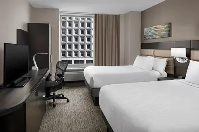 a hotel room with two beds and a television at Hilton Garden Inn NYC Financial Center/Manhattan Downtown in New York