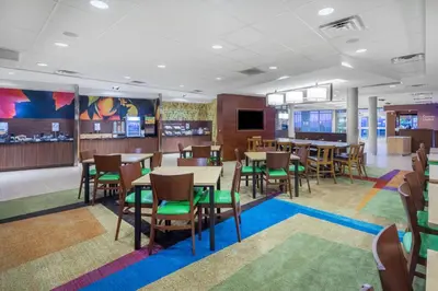a dining room with tables and chairs in a restaurant at Fairfield Inn & Suites by Marriott Bloomsburg in Bloomsburg