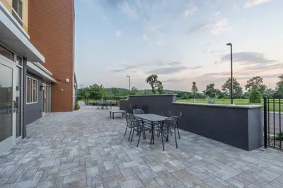 a patio with a table and chairs and a building at Fairfield Inn & Suites by Marriott Bloomsburg in Bloomsburg