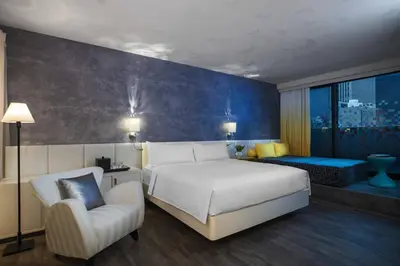 a bedroom with a large white bed and a chair at Renaissance New York Times Square by Marriott in New York