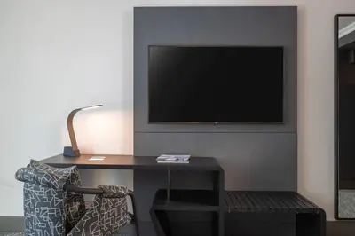 a room with a desk with a tv and a chair at Renaissance New York Times Square by Marriott in New York