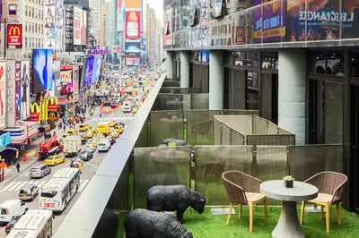 a balcony with a table and two bears on a city street at Renaissance New York Times Square by Marriott in New York