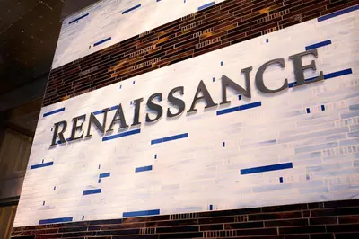 a sign for the rexassuranceurance building on a brick wall at Renaissance New York Times Square by Marriott in New York