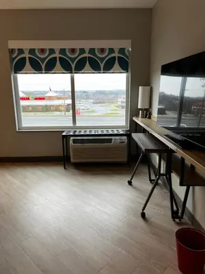 an empty room with a piano and a large window at Tru By Hilton Lancaster East in Lancaster