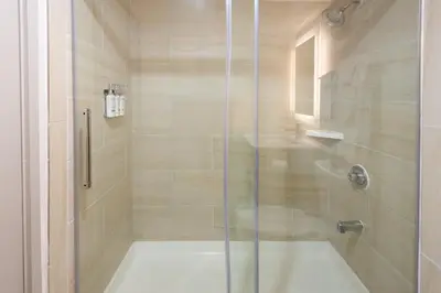 a shower with a glass door in a bathroom at Holiday Inn Express Philadelphia NE-Bensalem by IHG in Bensalem