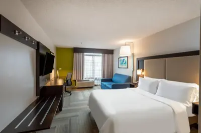 a hotel room with a white bed and a tv at Holiday Inn Express Philadelphia NE-Bensalem by IHG in Bensalem