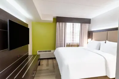 a bedroom with a large bed and a flat screen tv at Holiday Inn Express Philadelphia NE-Bensalem by IHG in Bensalem