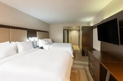 a hotel room with two beds and a flat screen tv at Holiday Inn Express Philadelphia NE-Bensalem by IHG in Bensalem