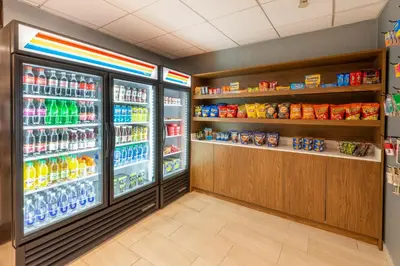 a store aisle with an open refrigerator with drinks at Holiday Inn Express Philadelphia NE-Bensalem by IHG in Bensalem