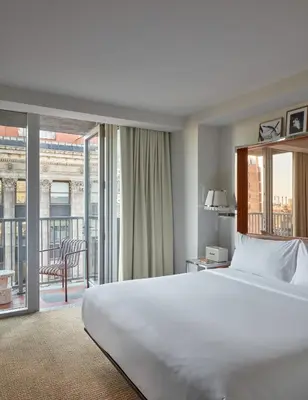 a hotel room with a bed and a large window at Hotel Park Ave NYC in New York