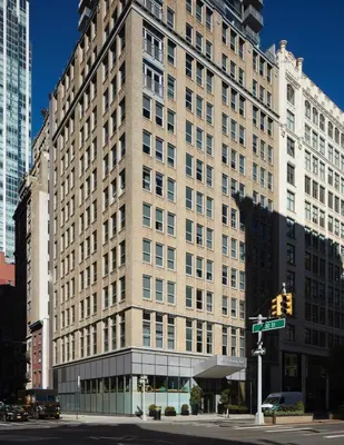 a large building on a city street with a traffic light at Hotel Park Ave NYC in New York
