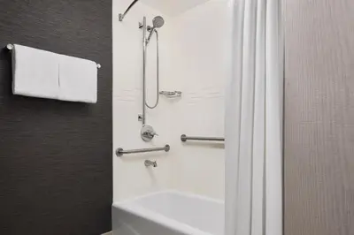 a bathroom with a shower and a white bath tub at Residence Inn by Marriott Harrisburg Carlisle in Carlisle