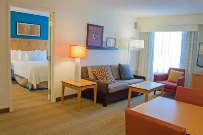 a hotel room with a couch and a bed at Residence Inn by Marriott Harrisburg Carlisle in Carlisle