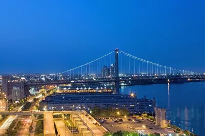 a bridge over the water at night with a city at Hilton Philadelphia at Penn's Landing in Philadelphia