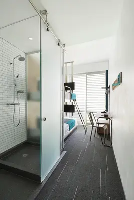 a bathroom with a shower and a bedroom at Pod Times Square in New York