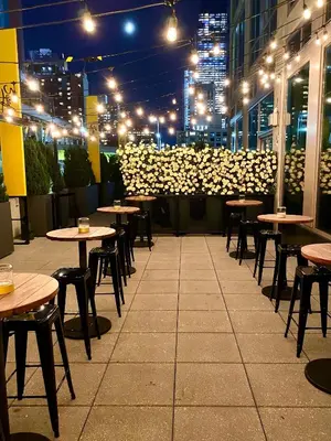 a row of tables and chairs in a restaurant at night at Pod Times Square in New York