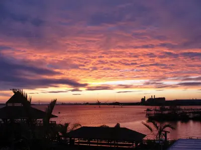 a sunset over a body of water with a sky at Waterfront Inn PHL Airport in Essington