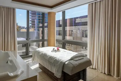 a bathroom with a bed and a large window at The Dominick Hotel in New York