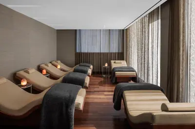 a waiting room with couches and a row of beds at The Dominick Hotel in New York