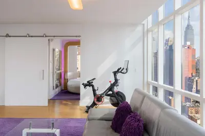 a living room with a scooter sitting on a couch at YOTEL New York Times Square in New York