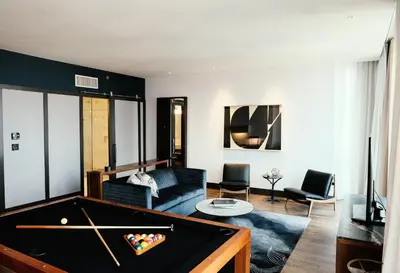 a living room with a pool table at Kimpton Hotel Eventi by IHG in New York
