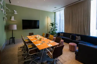 a conference room with a table and chairs and a couch at Kimpton Hotel Eventi by IHG in New York