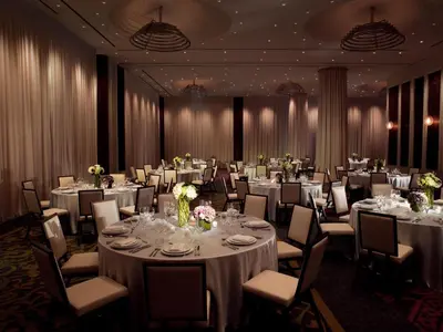 a ballroom with tables and chairs with white tablecloths at Kimpton Hotel Eventi by IHG in New York