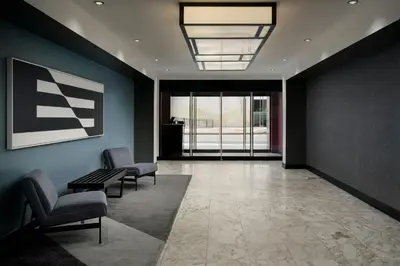 a lobby with two chairs and a bench in a building at Aloft Philadelphia Downtown in Philadelphia