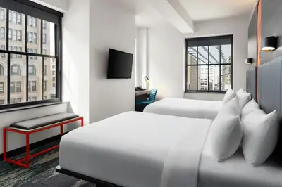 a hotel room with two beds and a tv at Aloft Philadelphia Downtown in Philadelphia