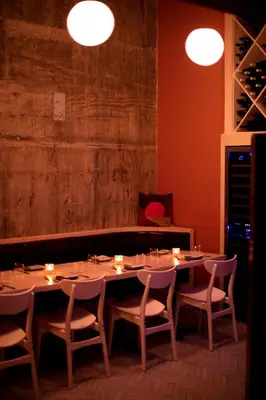 a dining room with a table and chairs and lights at Nolitan Hotel SoHo - New York in New York