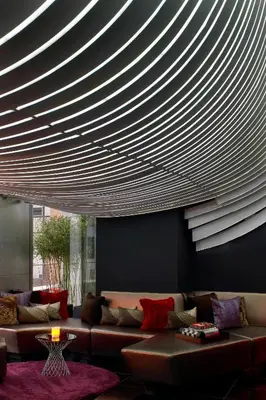 a living room with a couch and a circular ceiling at The Washington Hotel NYC in New York