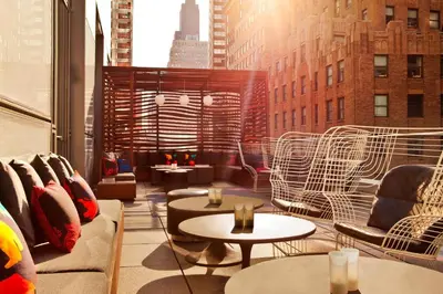 a room with chairs and tables in a building at The Washington Hotel NYC in New York